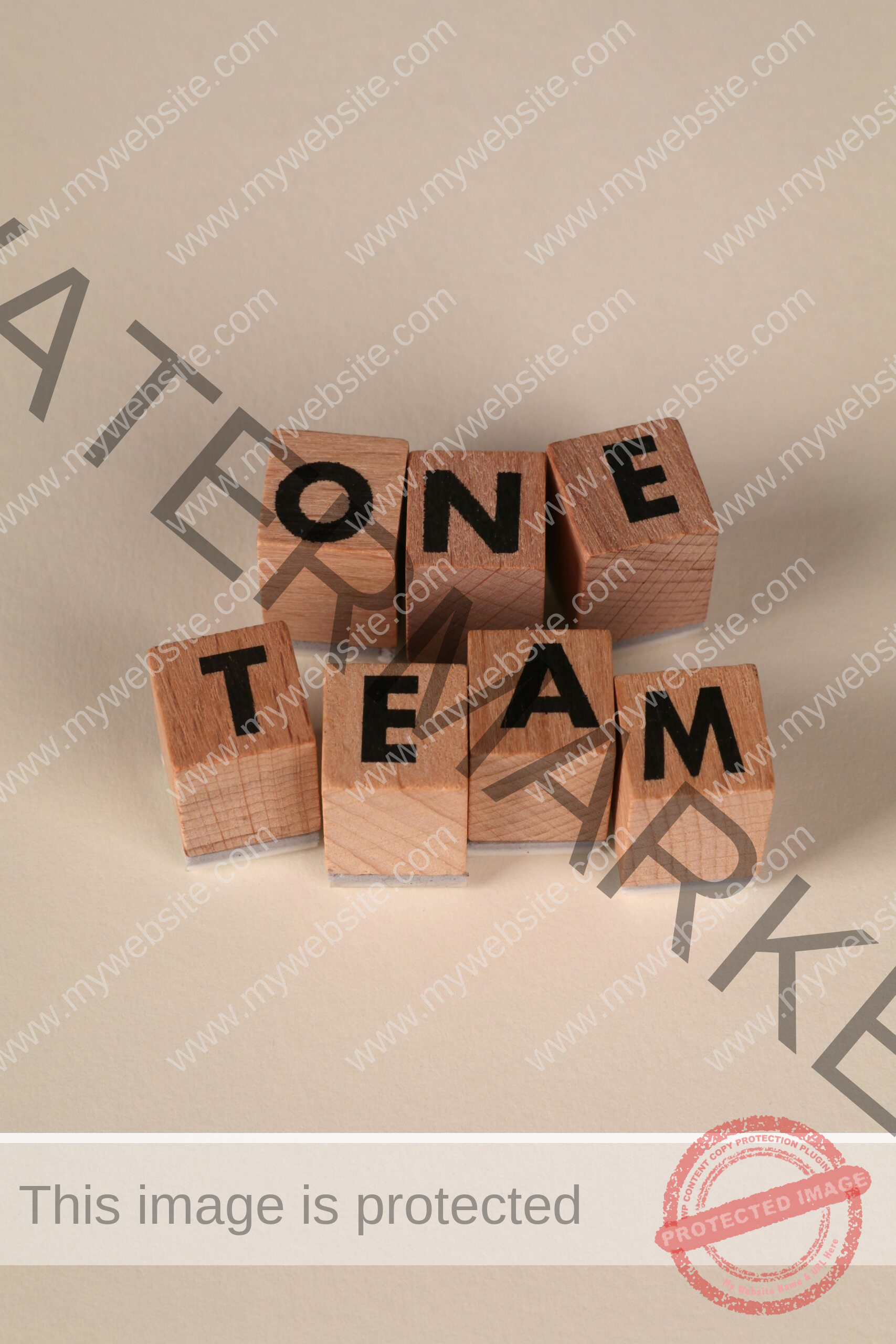 Wooden blocks arranged to spell 'One Team', symbolizing teamwork and unity.