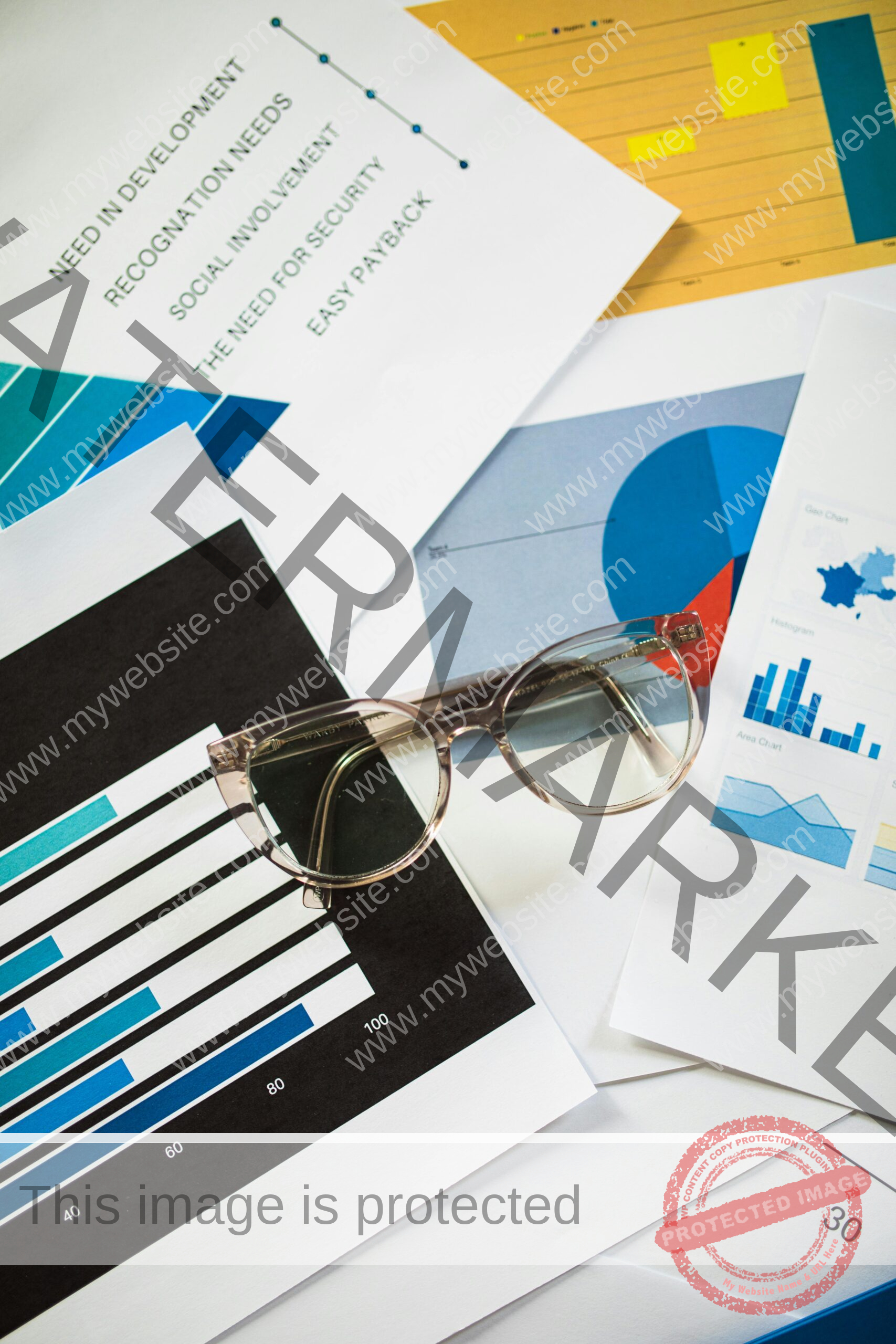 Eyeglasses resting on business charts and documents, ideal for financial analysis themes.