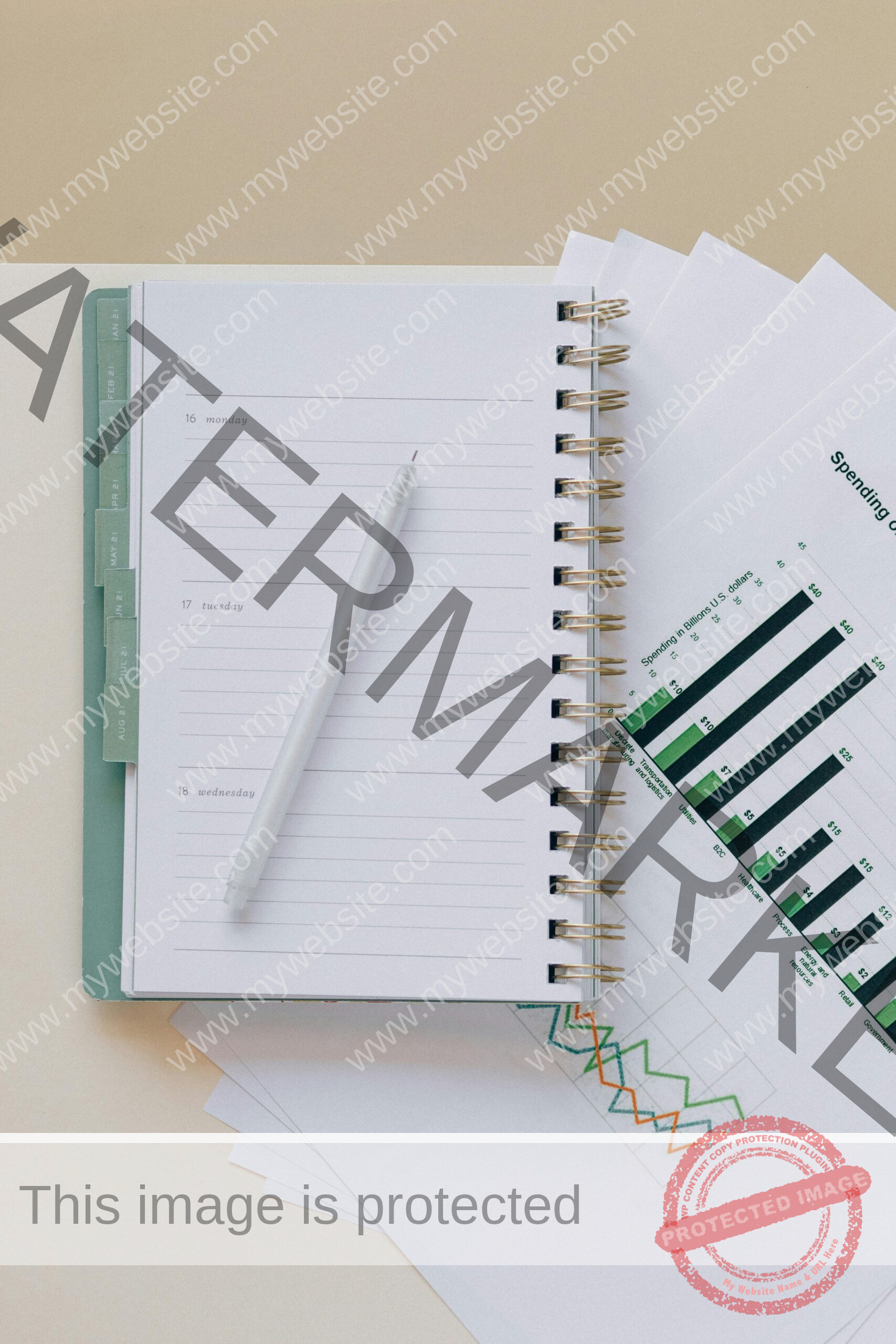 An open planner with a pen on top of graph sheets, perfect for planning and organization.